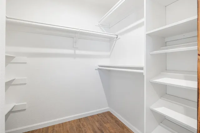 a view of walk in closet with empty racks