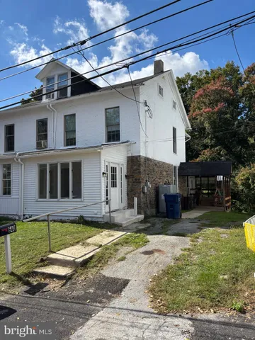 a view of a house with a yard in the background