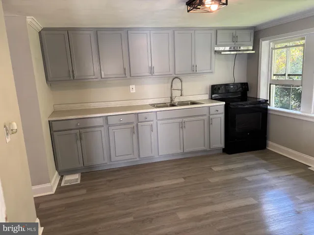 a kitchen with a sink and cabinets