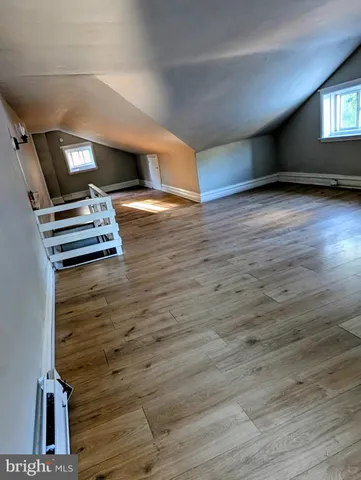 a view of an empty room with stairs and a window