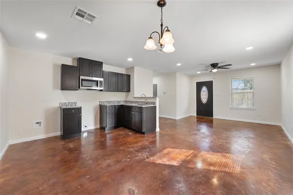 a view of a kitchen with a sink and a refrigerator