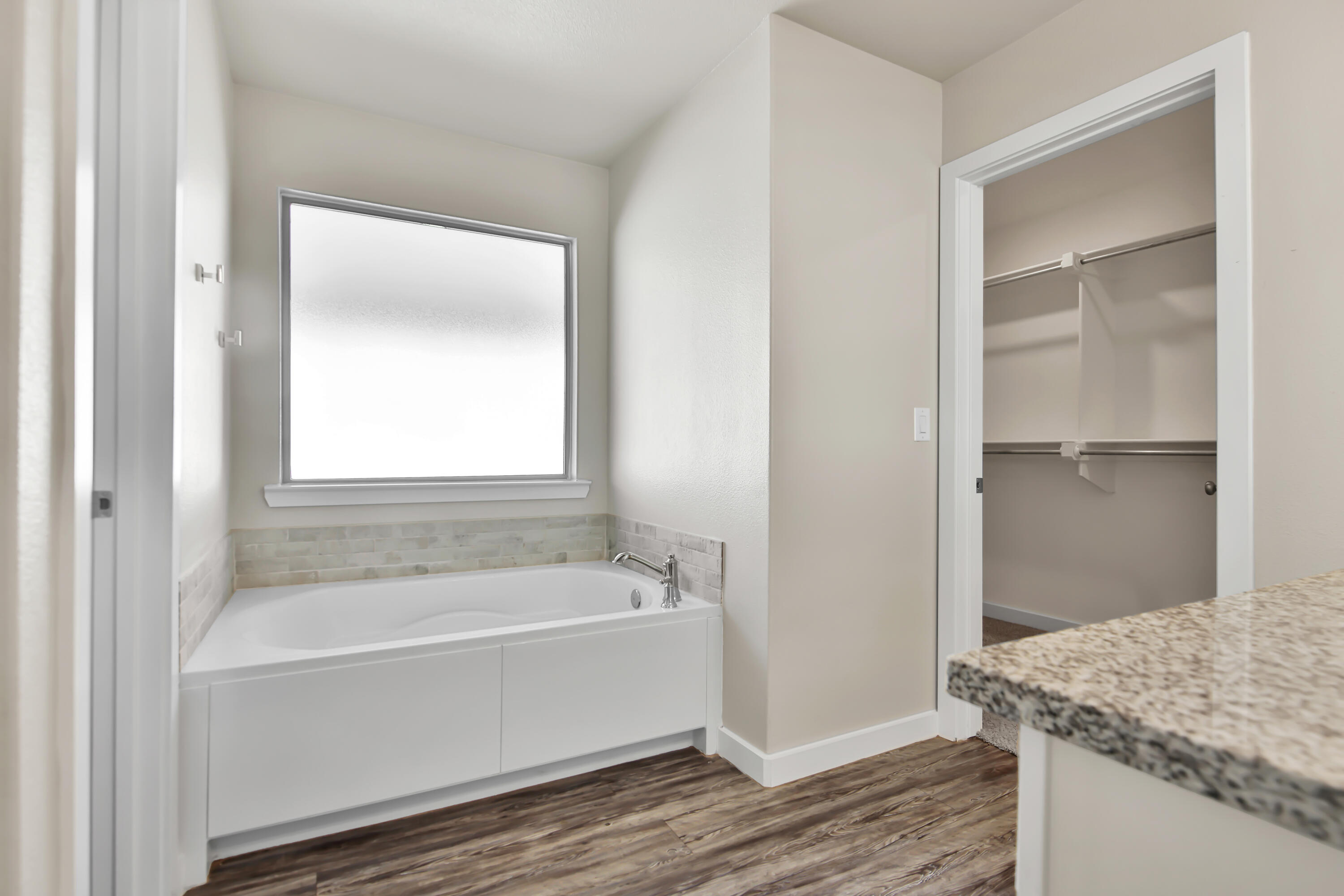3223 Volney Avenue Lubbock, TX 79407 - Photo 17 of 29 a white bath tub sitting next to a bathroom sink