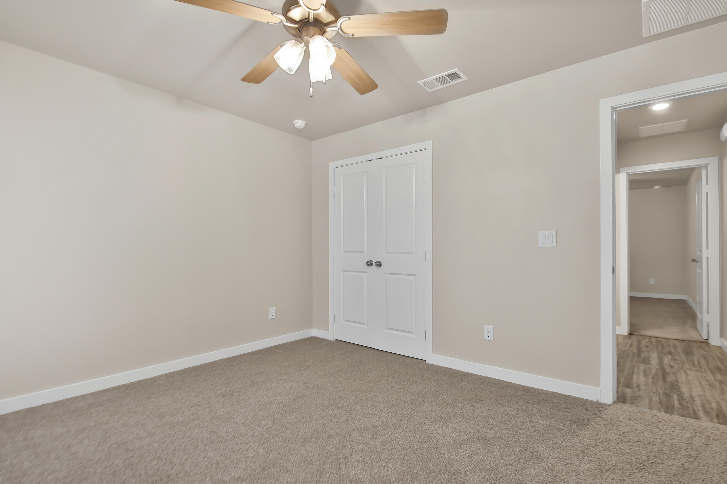 3223 Volney Avenue Lubbock, TX 79407 - Photo 22 of 29 an empty room with a chandelier fan and closet area