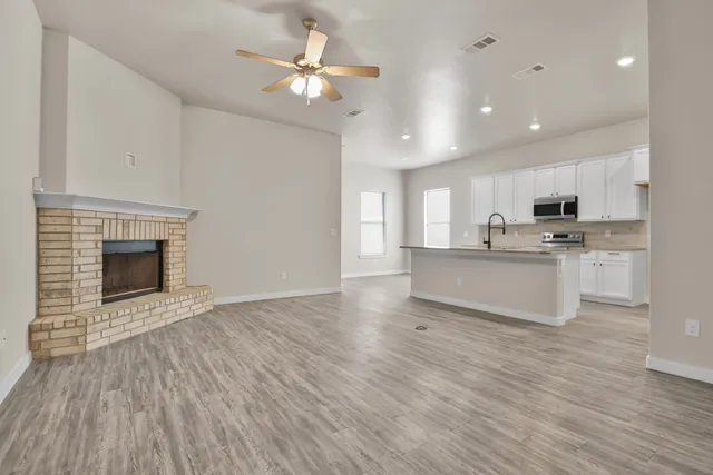 a view of kitchen with granite countertop cabinets and wooden floor