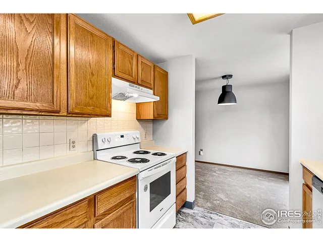 a kitchen with stainless steel appliances a stove a refrigerator and cabinets