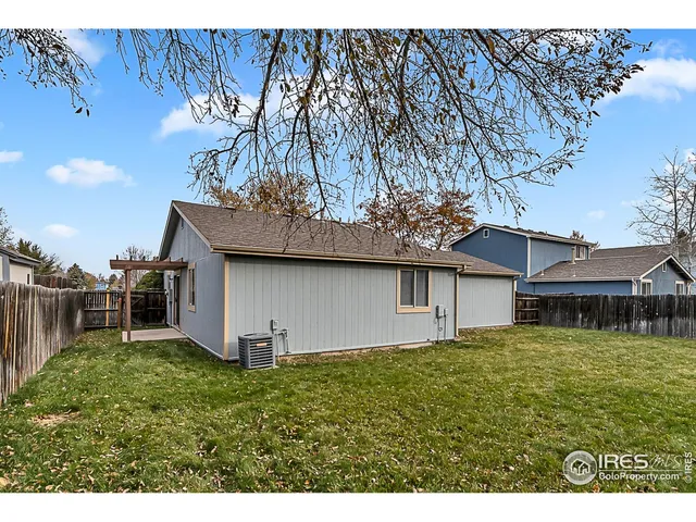 a backyard of a house with table and chairs