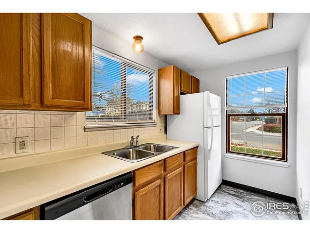 a kitchen with a sink cabinets and window