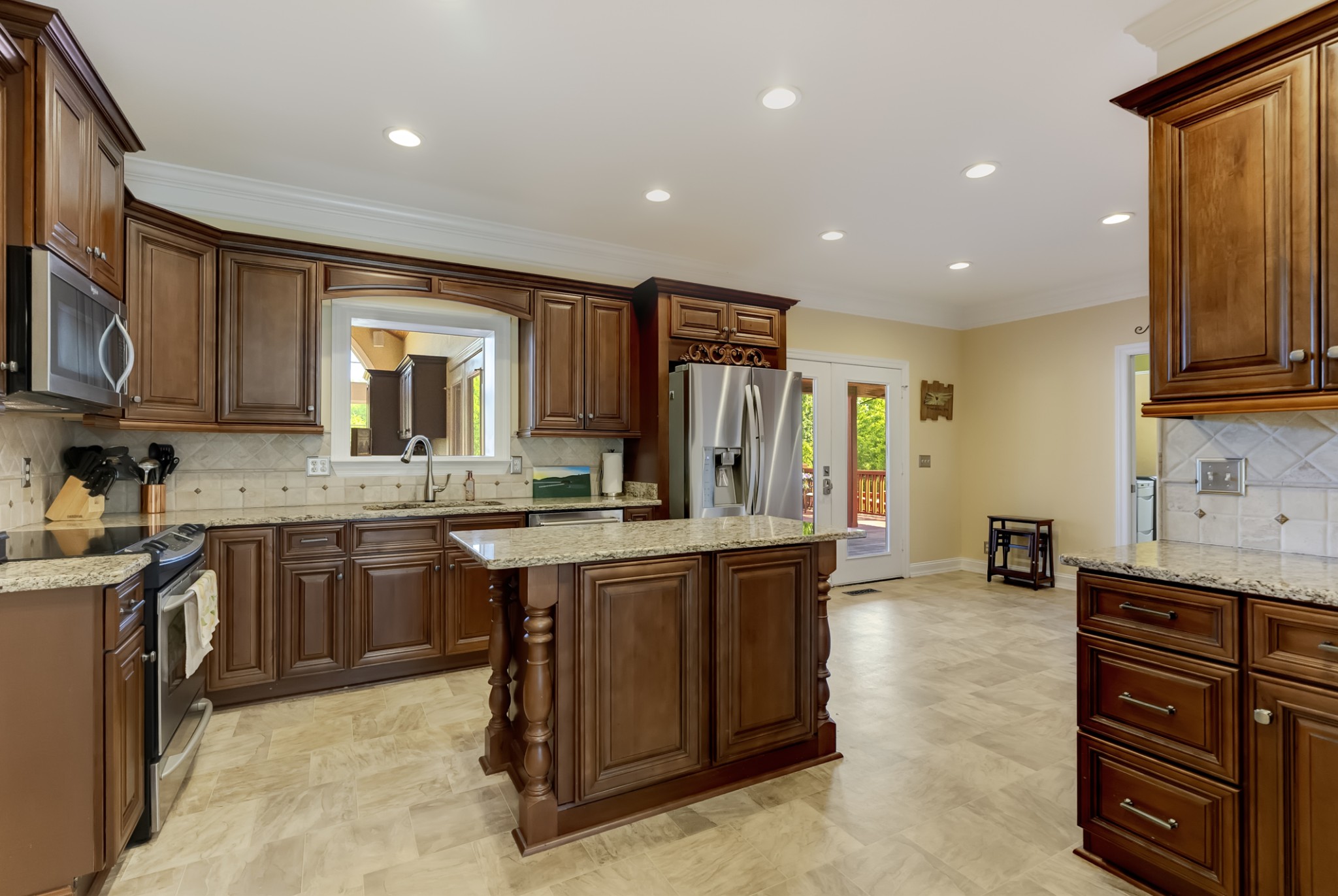 1446 Kittrell Road Franklin, TN 37064 - Photo 13 of 71 a kitchen with stainless steel appliances granite countertop wooden cabinets a sink and dishwasher