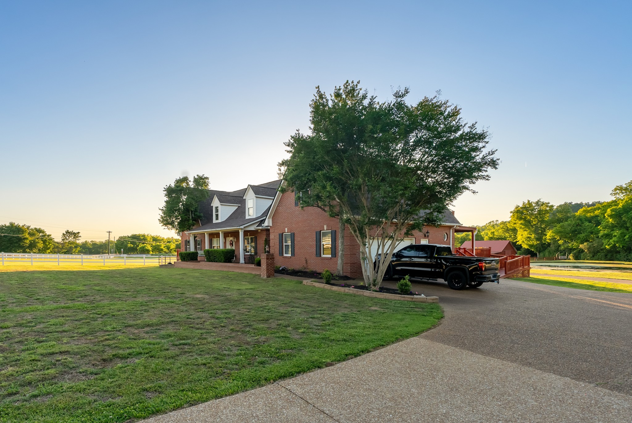 1446 Kittrell Road Franklin, TN 37064 - Photo 55 of 71 a car parked in front of a house next to a big yard