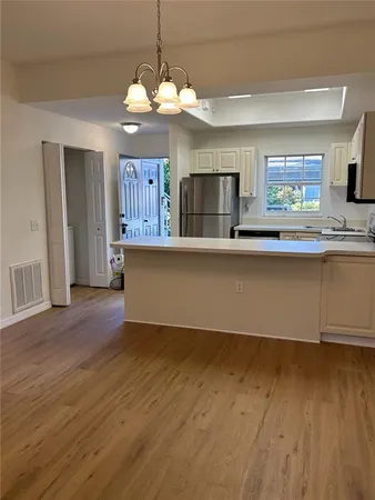 a view of kitchen with granite countertop cabinets and wooden floor