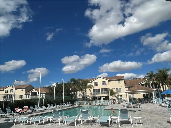 a view of a lake with a house swimming pool and outdoor space