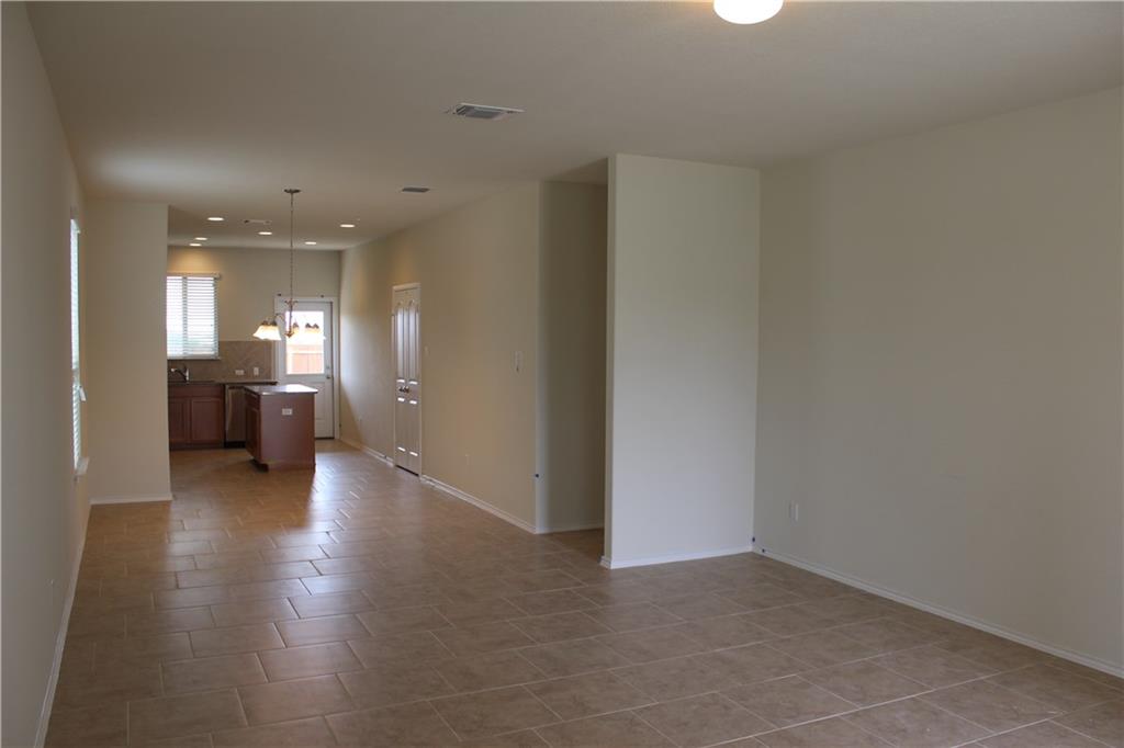 525 Coffee Berry Drive Georgetown, TX 78626 - Photo 2 of 8 Empty room featuring a chandelier, light tile patterned floors, and recessed lighting