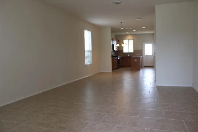 a view of a room window and wooden floor