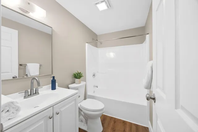 a bedroom with a bed and a potted plant