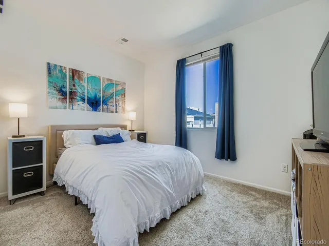 a bedroom with a bed and window