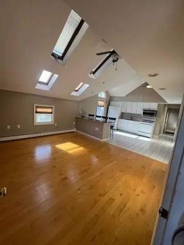 a view of kitchen and dining room with wooden floor