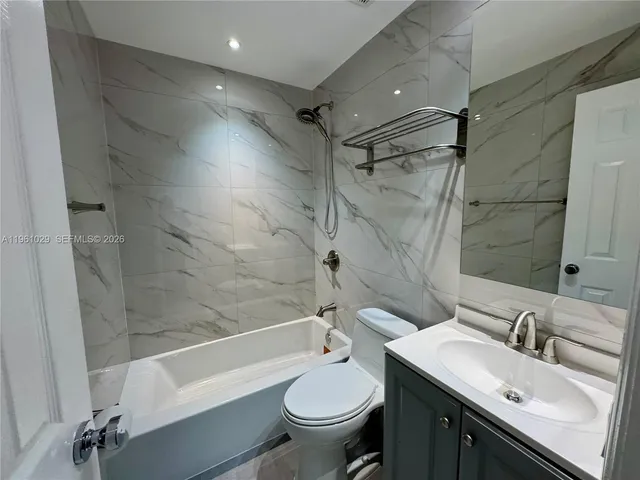 a bathroom with a sink toilet tub and shower