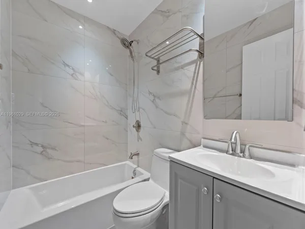 a bathroom with a sink a toilet and a bathtub