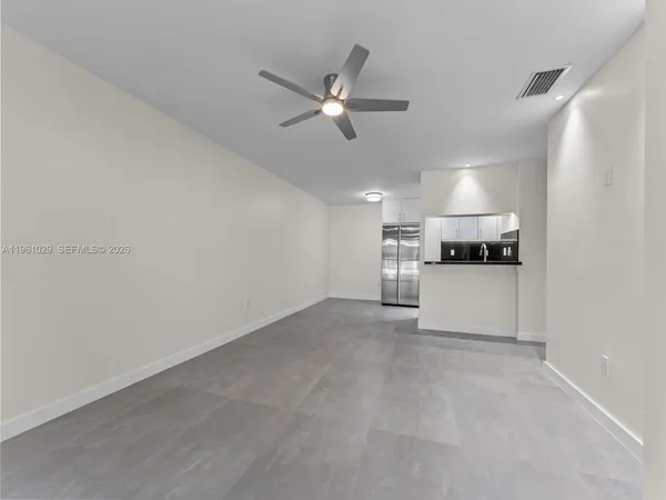 a view of a kitchen with a sink and dishwasher a refrigerator with wooden floor