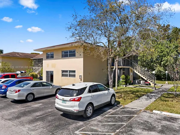 a view of cars parked in front of a house