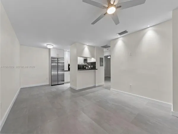 a view of a kitchen with a sink and a ceiling fan