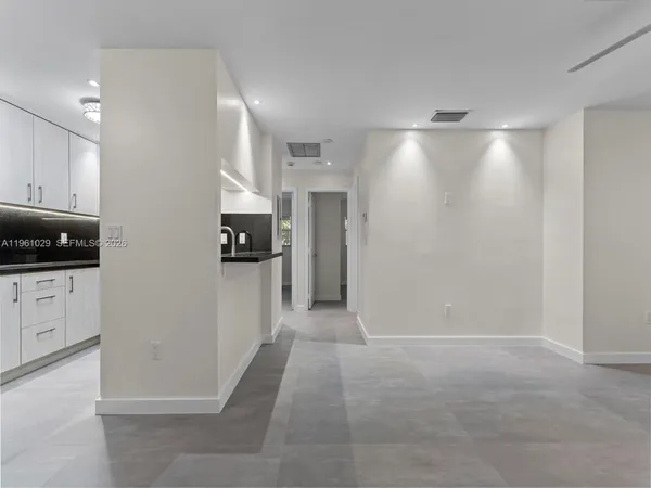 a view of a kitchen with a refrigerator and cabinets