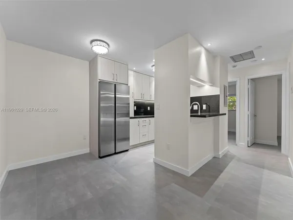 a view of a kitchen with a refrigerator and a stove