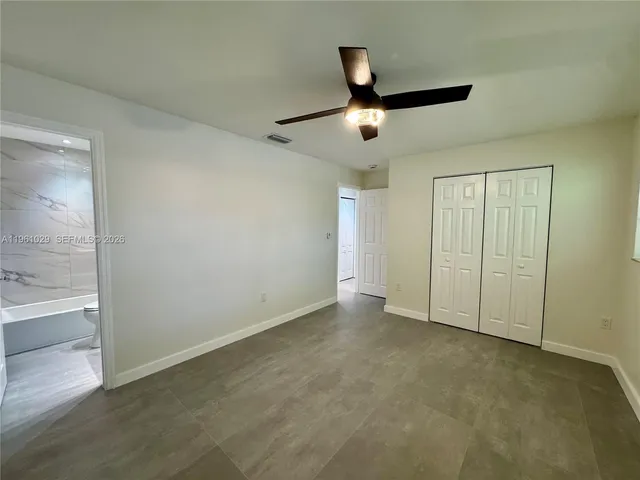 an empty room with a empty space and a ceiling fan