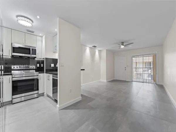 a view of a kitchen with dishwasher and a stove top oven