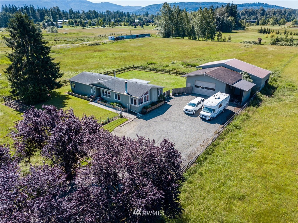 1475 East Smith Road Bellingham, WA 98226 - Photo 1 of 27 an aerial view of a house with garden space and lake view