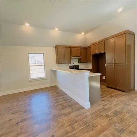a kitchen with stainless steel appliances a refrigerator sink and microwave