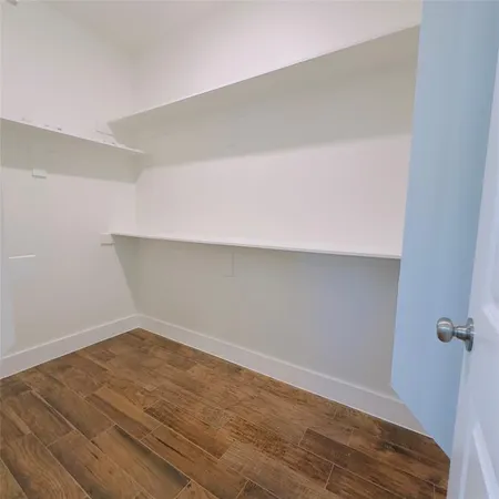 a view of a room with wooden floor