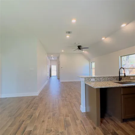 a view of a kitchen with a sink and a refrigerator