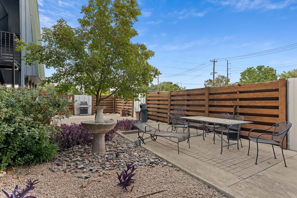 3815 Guadalupe Street, Unit 303 Austin, TX 78751 - Photo 18 of 21 Fenced backyard with a patio area and outdoor dining area