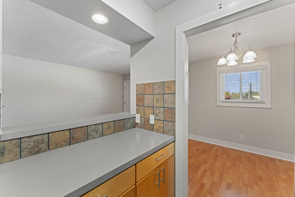 3815 Guadalupe Street, Unit 303 Austin, TX 78751 - Photo 6 of 21 Kitchen with light wood-type flooring, a chandelier, hanging light fixtures, and light countertops