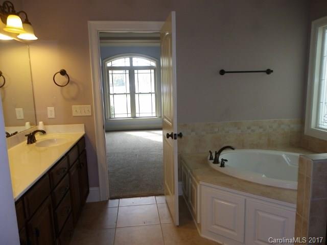 1808 Sam Smith Road Fort Mill, SC 29708 - Photo 10 of 20 a bathroom with a tub sink and mirror