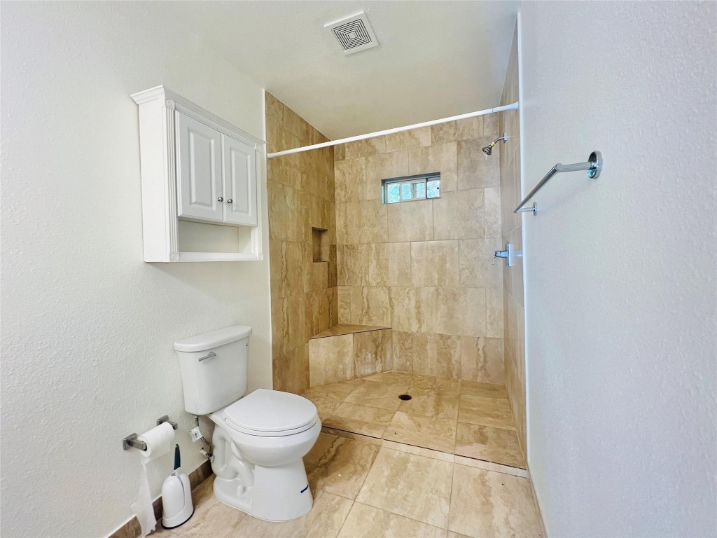 936 Bennington Street Houston, TX 77022 - Photo 11 of 12 a bathroom with a toilet and shower