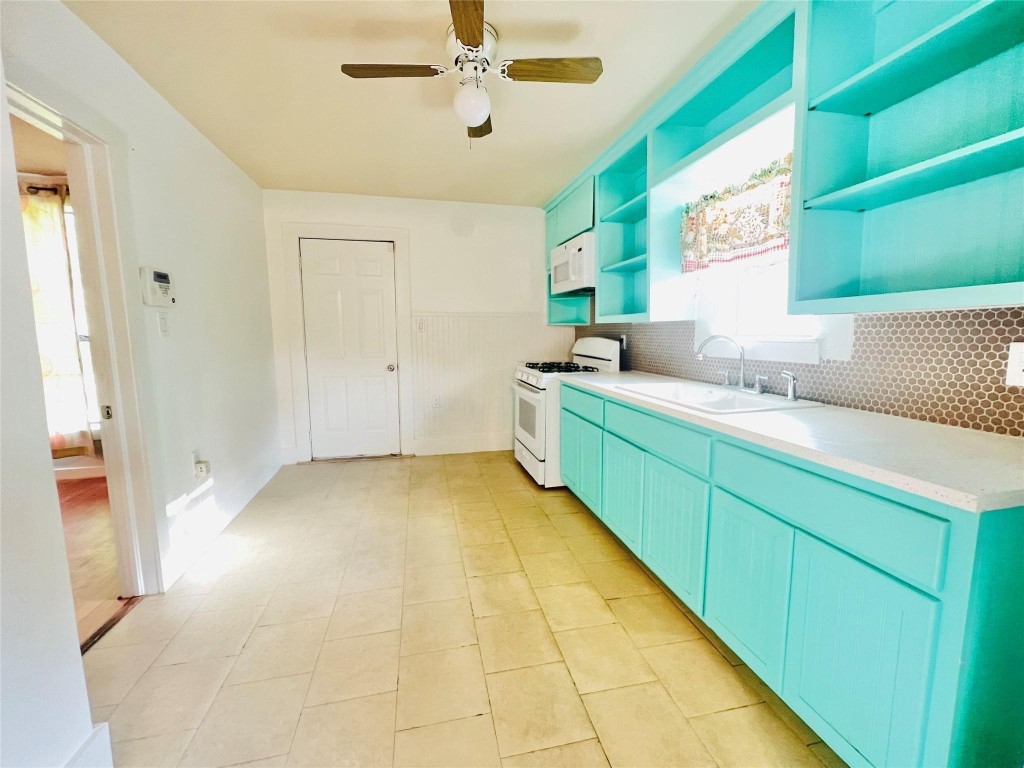 936 Bennington Street Houston, TX 77022 - Photo 3 of 12 a bathroom with a granite countertop sink and a mirror