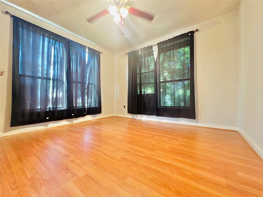 936 Bennington Street Houston, TX 77022 - Photo 6 of 12 a view of an empty room with wooden floor and a window