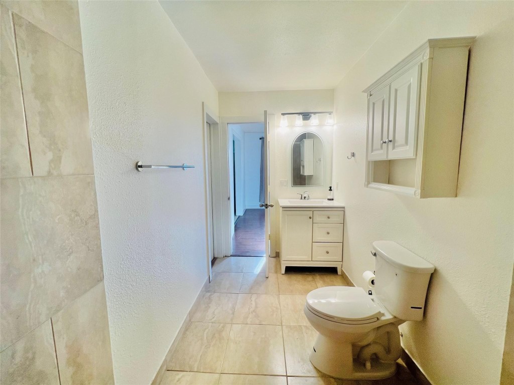 936 Bennington Street Houston, TX 77022 - Photo 10 of 12 a bathroom with a toilet sink and mirror