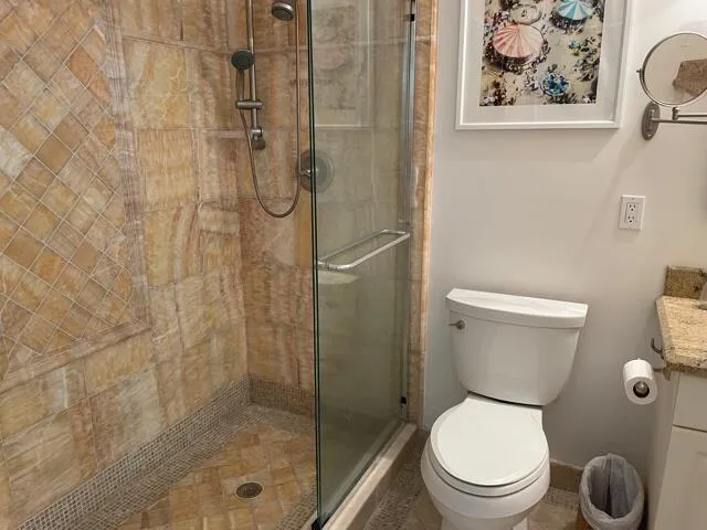 a white toilet sitting next to a bathroom sink