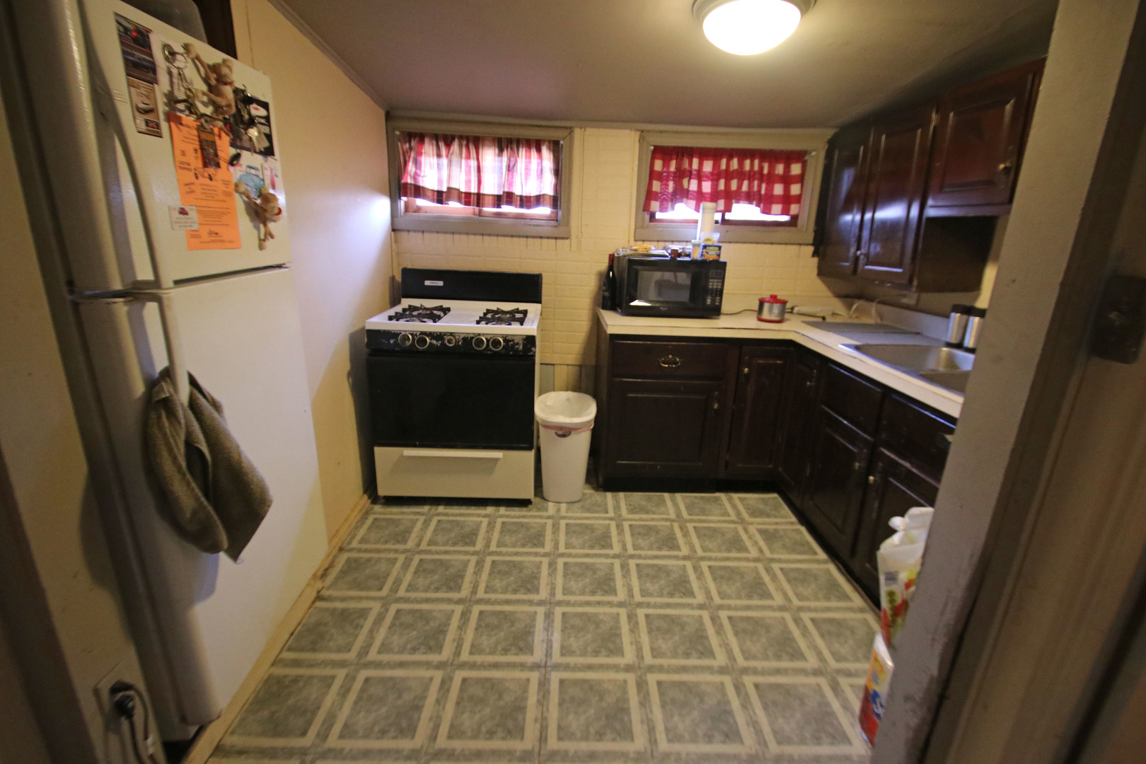 47 North Pistakee Lake Road Fox Lake, IL 60020 - Photo 10 of 15 a kitchen with a sink a stove and cabinets