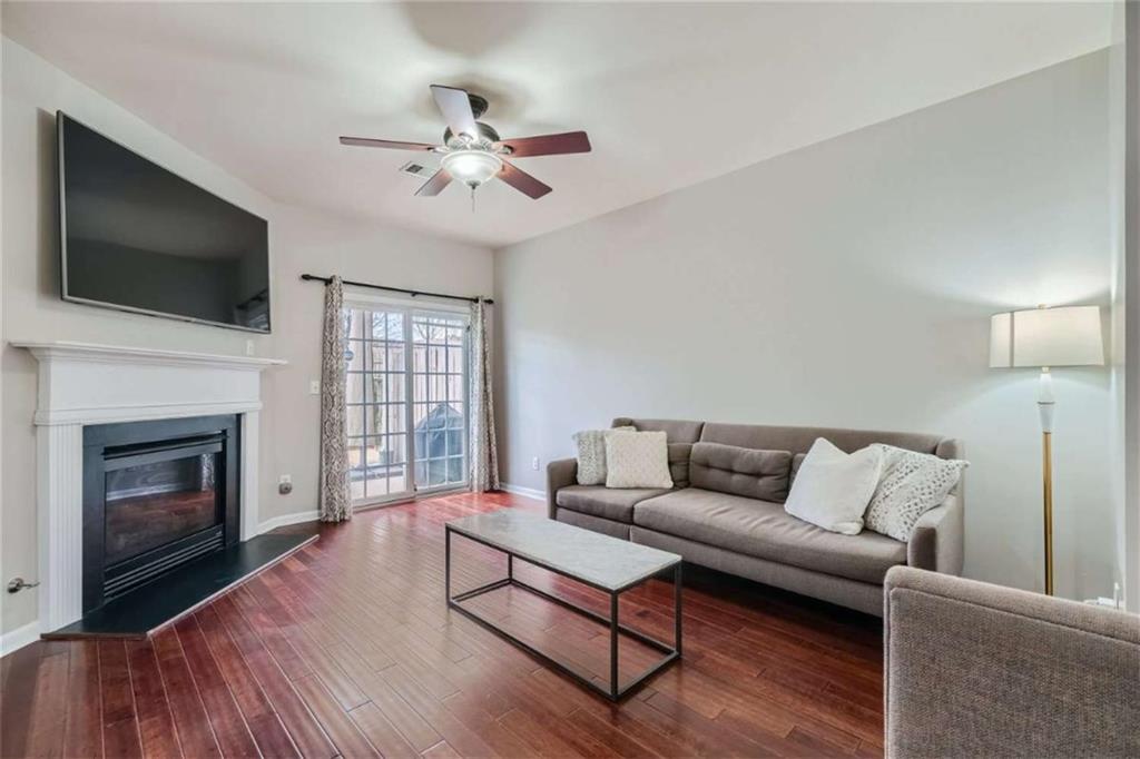 2296 Leicester Way Southeast Atlanta, GA 30316 - Photo 4 of 11 a living room with furniture fireplace and flat screen tv