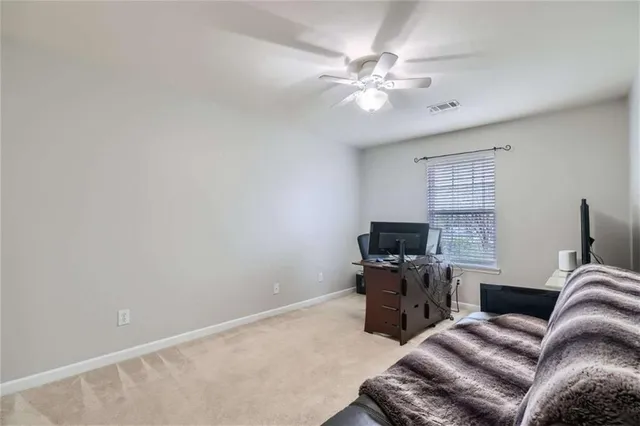 a view of a livingroom with workspace and a window