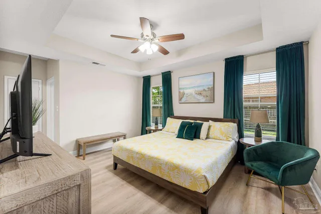 a bedroom with a bed window and a couch