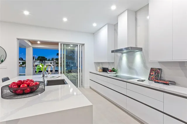 a kitchen with counter top space a sink and stainless steel appliances