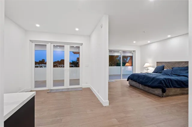 a bedroom with a large bed and a flat screen tv