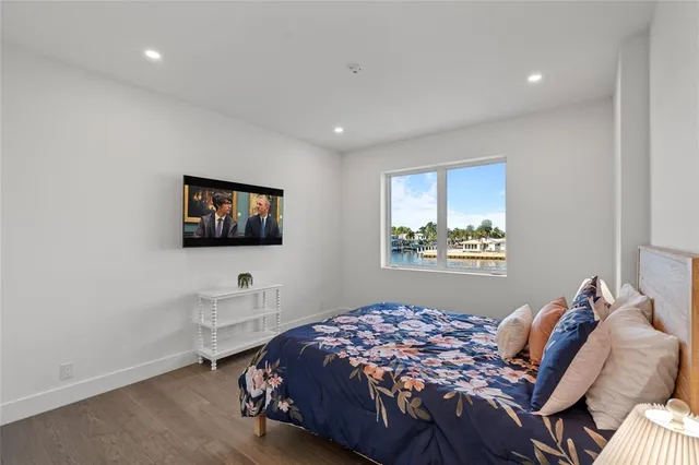 a bedroom with furniture and a flat screen tv