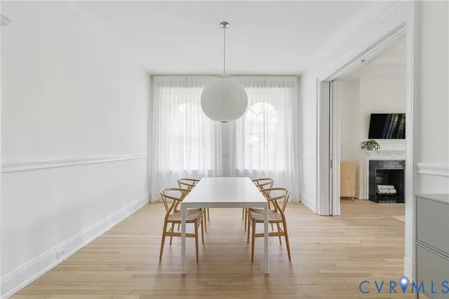 a dining room with a table and chairs
