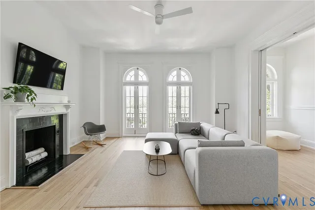 a living room with furniture a fireplace and a flat screen tv